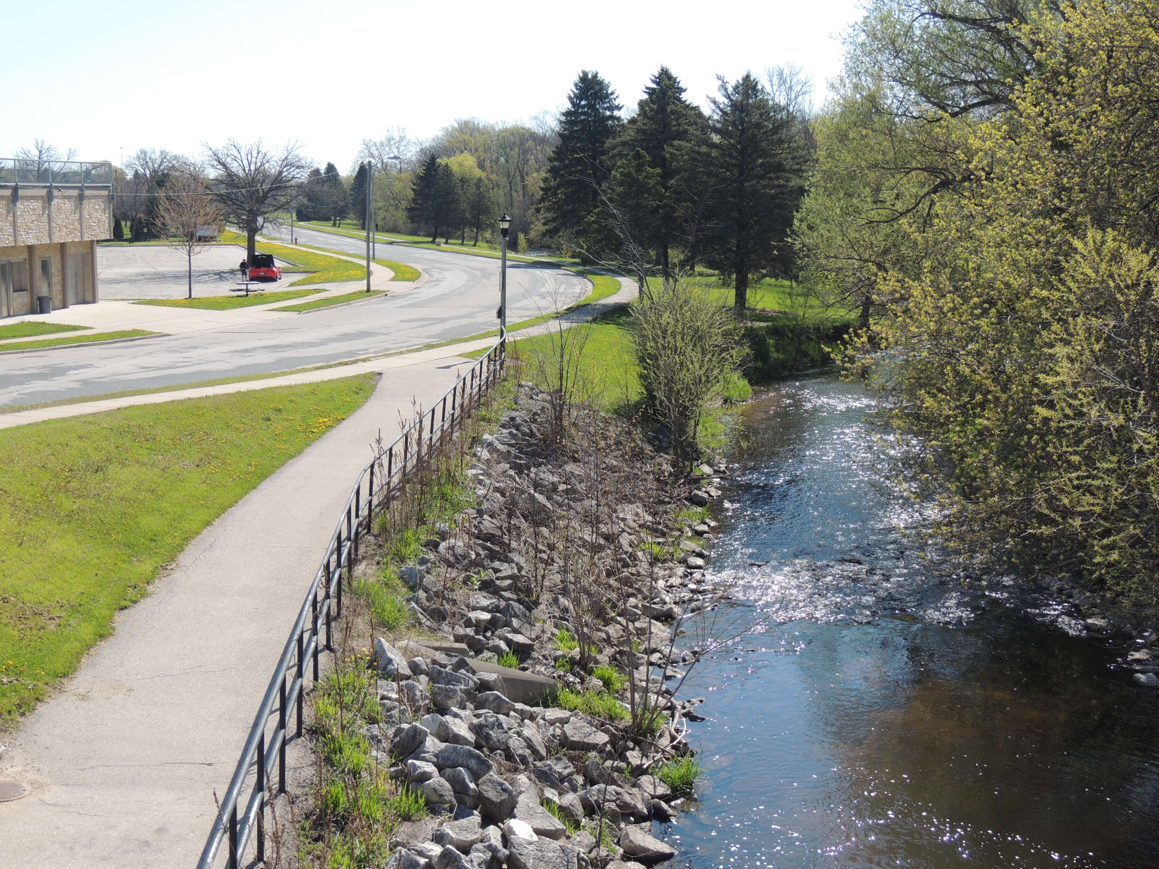 Riverside Park Body of Water Next to a Sidewalk