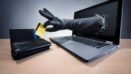 Image of hand coming out of computer to take a credit card (photo)