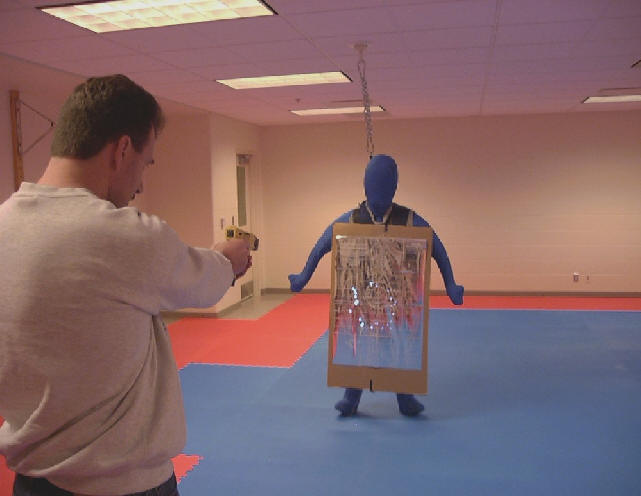 Man has target practice at dummy figure
